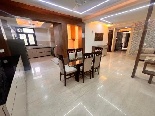 a kitchen and dining room with a table and chairs at Gazebo Inn & Suites Medanta in Gurgaon