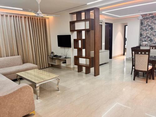 a living room with a couch and a table at Gazebo Inn & Suites Medanta in Gurgaon