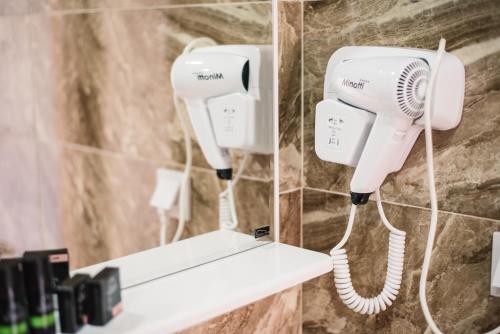 two hair dryers on a wall in a bathroom at Hotel NOBEL Ulcinj in Ulcinj