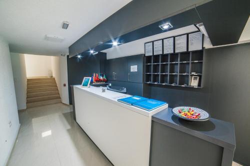 a kitchen with a counter with a bowl of candy at Hotel NOBEL Ulcinj in Ulcinj