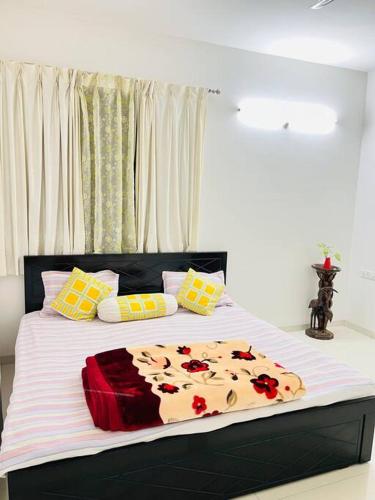 a bedroom with a large bed with flowers on it at BRIJ Homes- 2 Bedroom Premium Apartment in Indore