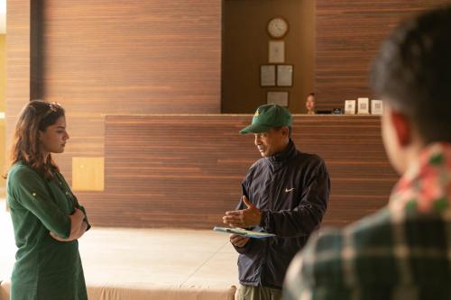 a man and a woman standing in a room at Kasara Chitwan in Chitwan