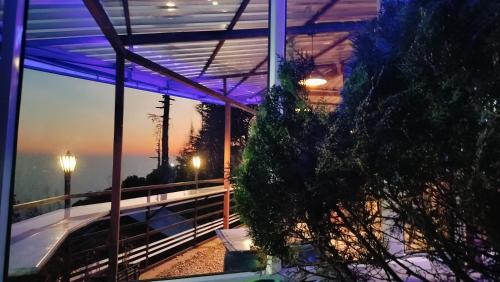 a view of a building with a balcony at night at Paradiso Guest House in McLeod Ganj