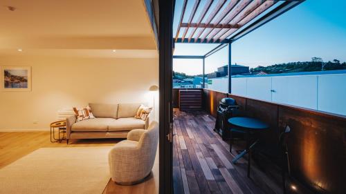 a living room with a couch and a window at Beautiful urban apartment 4 in Nelson