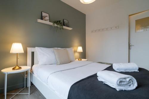 une chambre avec un grand lit blanc et deux lampes dans l'établissement Hypercentre - 2 pièces confortable, à Lille