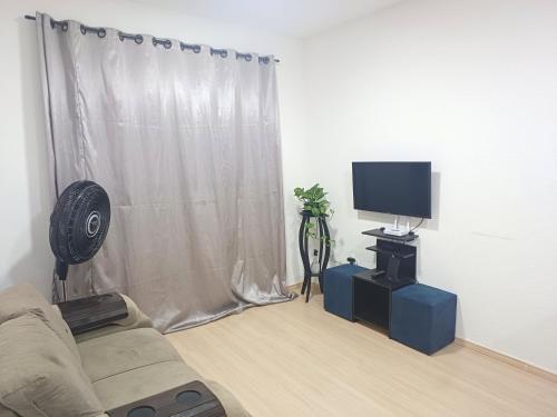 a living room with a couch and a television at Apê no Centro de Madureira in Rio de Janeiro