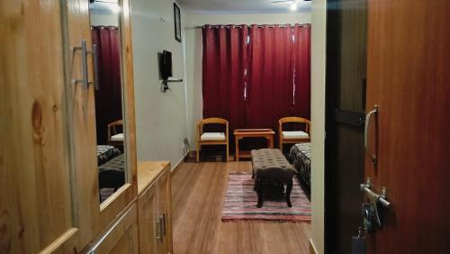 a hallway with a room with a red curtain at Paradiso Guest House in McLeod Ganj
