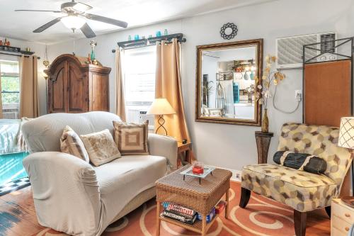 a living room with a couch and a chair at The Coziest Cottage in Waxahachie in Waxahachie
