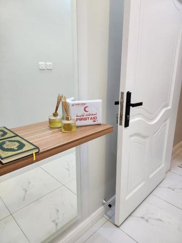 a room with a door and a book on a counter at شقة عائلية فخمة in Al Madinah