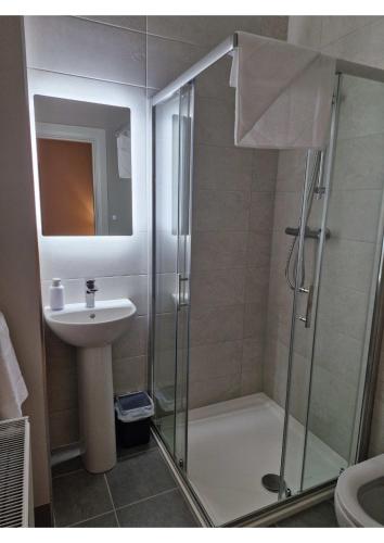 a bathroom with a shower and a sink at Station Lodge in Sligo
