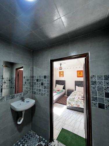 a bathroom with a sink and a bed and a mirror at Riad Palais D'Or in Rabat