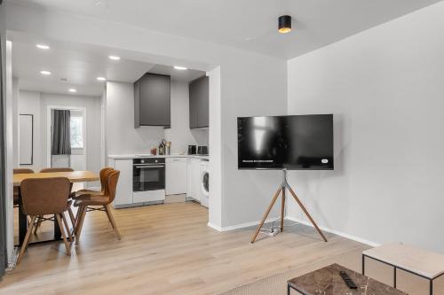 a living room with a table and a tv on a wall at U16 by Stay in Iceland in Reykjavík