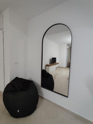 a mirror with a bean bag chair in a room at Appartement Cozy aux Berges du Lac 1 in Tunis