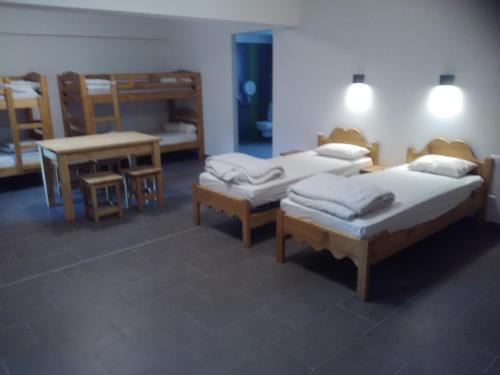 a room with three beds and a table and two bunk beds at Cap Verb Guillestre in Guillestre