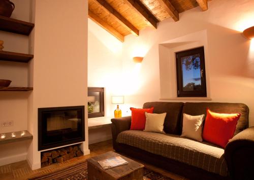a living room with a couch and a fireplace at Sernadinha in Aldeia do Cano