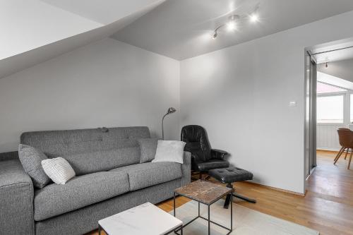 a living room with a couch and a chair at U16 by Stay in Iceland in Reykjavík