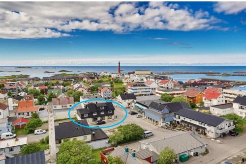an aerial view of a small town with a blue circle at Andenes Sentrum Apartment in Andenes
