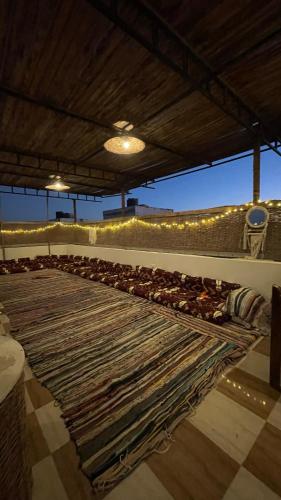 a large rug laying on the floor of a room with a large rug at La Casa Guest House in Marsa Alam City