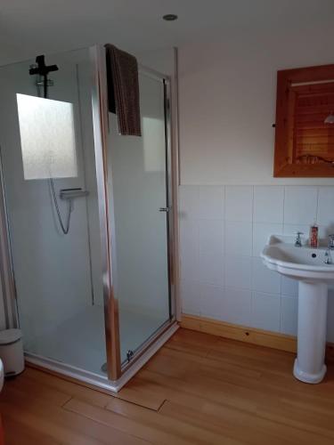 a bathroom with a shower and a sink at Bamboo Retreat in Louth