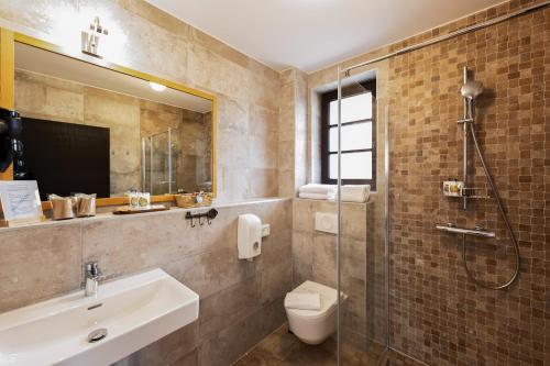 a bathroom with a sink and a toilet and a shower at B&B Plitvice Queen in Plitvička Jezera