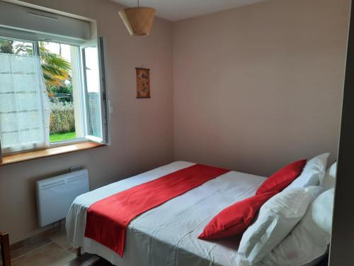 a bedroom with a bed with a red blanket at La Pêcherie d'Utah in Audouville-la-Hubert