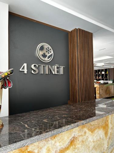 a black wall with the stiner logo on it at 4 Stinët in Valbonë