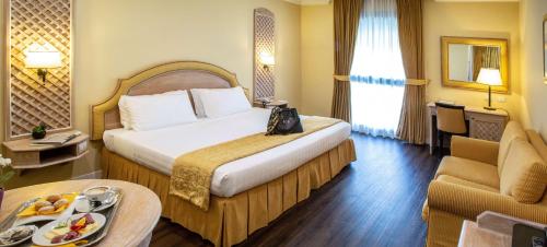 a hotel room with a large bed and a table at Best Western Park Hotel Roma Nord in Fiano Romano