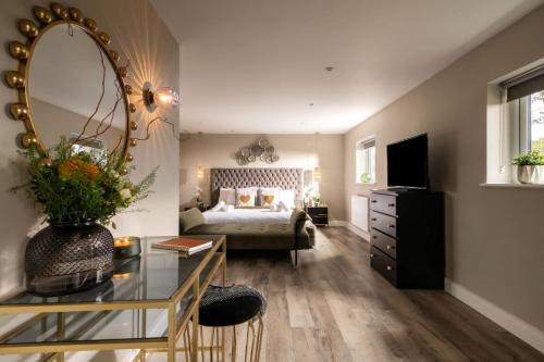 a bedroom with a bed and a large mirror at Sunset Cottage in Sandwich