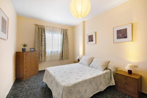 a bedroom with a large bed and a window at Casa Fefa in Candelaria