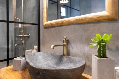 a bathroom with a concrete sink and a mirror at Onar Villa Kolympia in Kolimbia