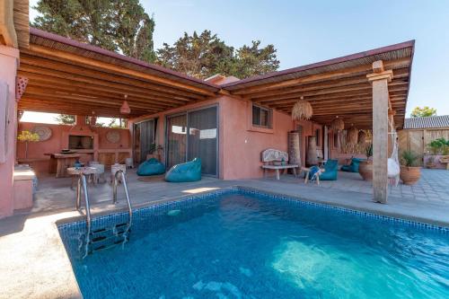 a house with a swimming pool and a patio at Onar Villa Kolympia in Kolimbia