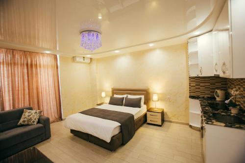 a bedroom with a bed and a couch at Holidays in Panorama Batumi in Batumi