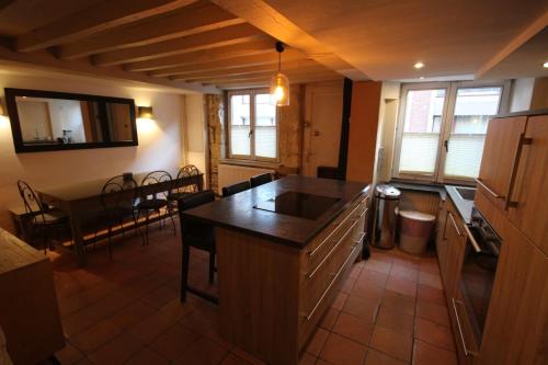 a kitchen with a sink and a table in a room at Old Town - Lovely typical house in Lille