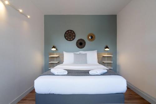 a bedroom with a large white bed with lights at Grand' Place of Lille - Superb designer apartment in Lille