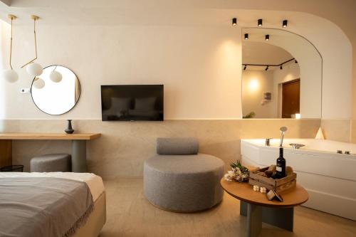 a bedroom with a bed and a bathroom with a tub at Sea & the City in Thessaloniki