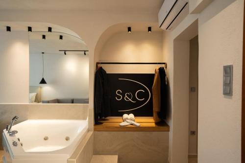 a bathroom with a bath tub and a sink at Sea & the City in Thessaloniki