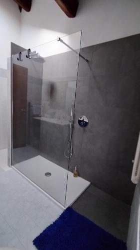 a shower with a glass door in a bathroom at Da Nataly in Fumane