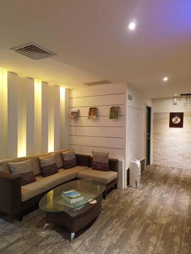 a living room with a couch and a glass table at 文化信然 in Tainan