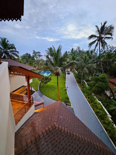 a view of a road from a house with palm trees at Savera Seafront in Suratakal