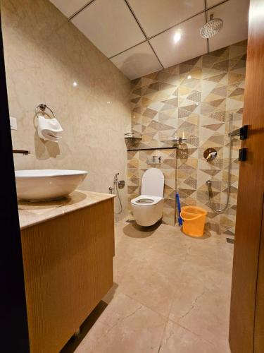 a bathroom with a toilet and a sink and a shower at Savera Seafront in Suratakal