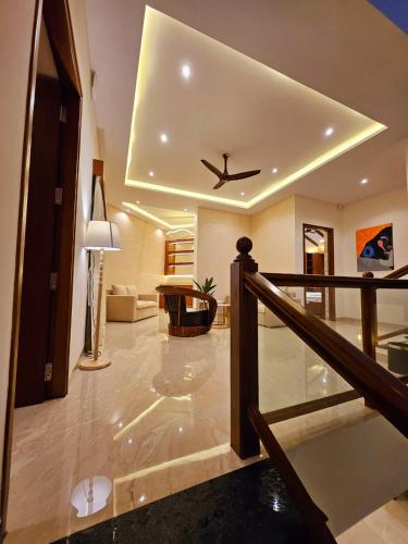a living room with a ceiling fan in a house at Savera Seafront in Suratakal
