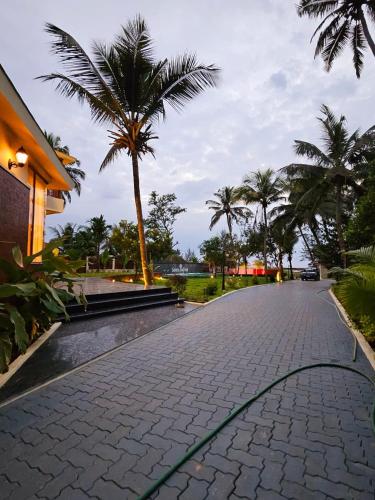 a cobblestone street with a green hose on it at Savera Seafront in Suratakal