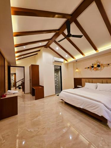 a bedroom with a large bed in a room at Savera Seafront in Suratakal