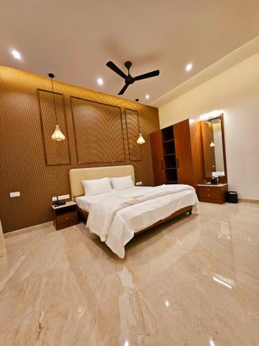 a bedroom with a bed and a ceiling fan at Savera Seafront in Suratakal
