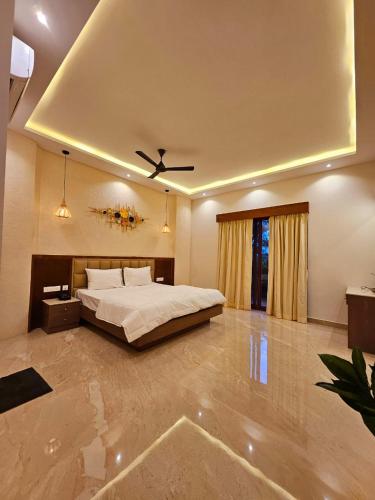 a bedroom with a bed and a ceiling fan at Savera Seafront in Suratakal