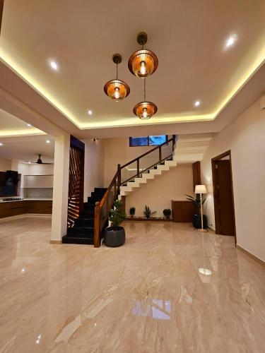a living room with a staircase in a house at Savera Seafront in Suratakal