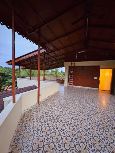 a large building with a tiled floor and a staircase at Savera Seafront in Suratakal