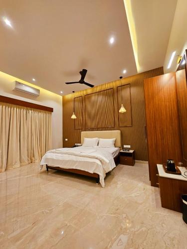 a large bedroom with a bed and a ceiling at Savera Seafront in Suratakal