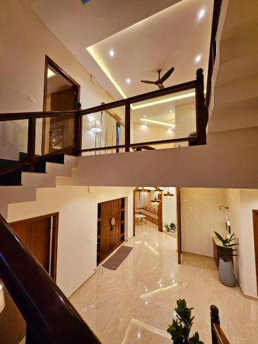 a living room with a staircase in a house at Savera Seafront in Suratakal