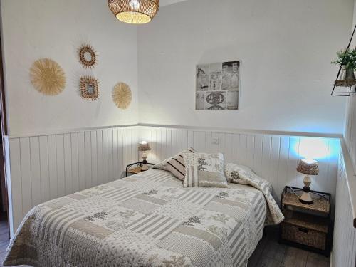 a bedroom with a bed and two pictures on the wall at chambres d'hôtes Amets in Sare